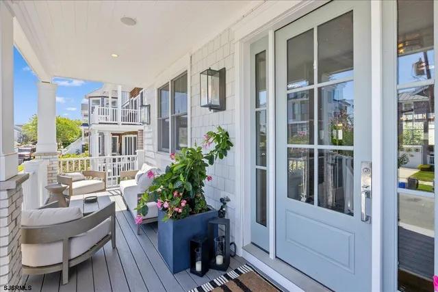 a living room with furniture kitchen view and a chandelier