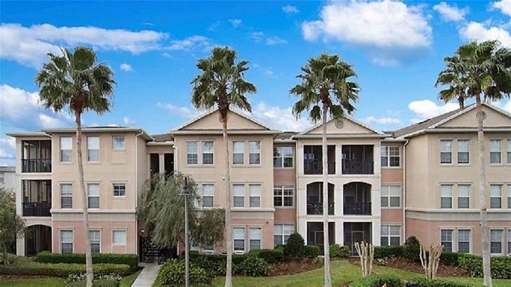 a front view of a residential apartment building with a yard