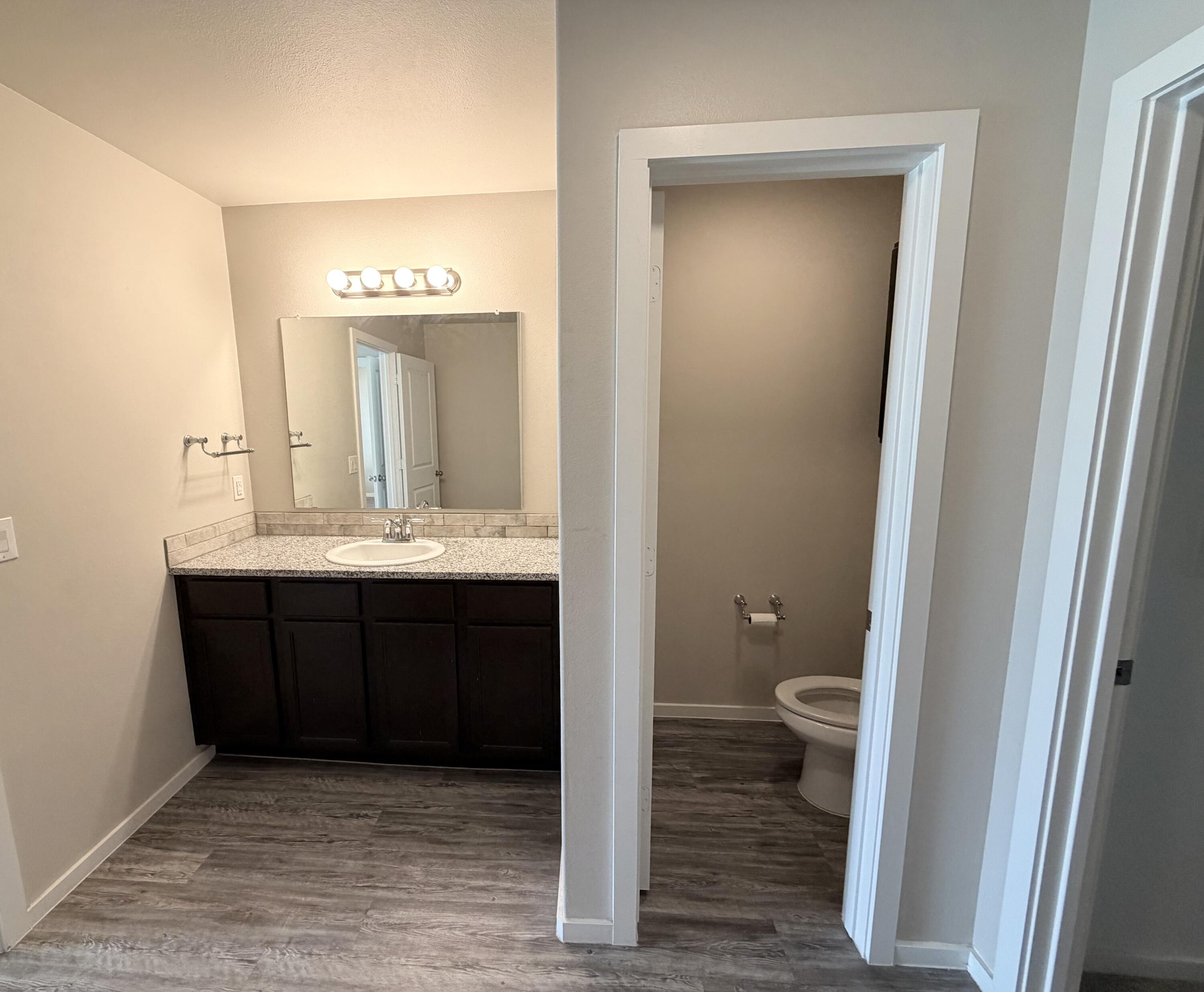 1619 133rd Street, Unit B Lubbock, TX 79423 - Photo 18 of 24 a bathroom with a sink and a mirror