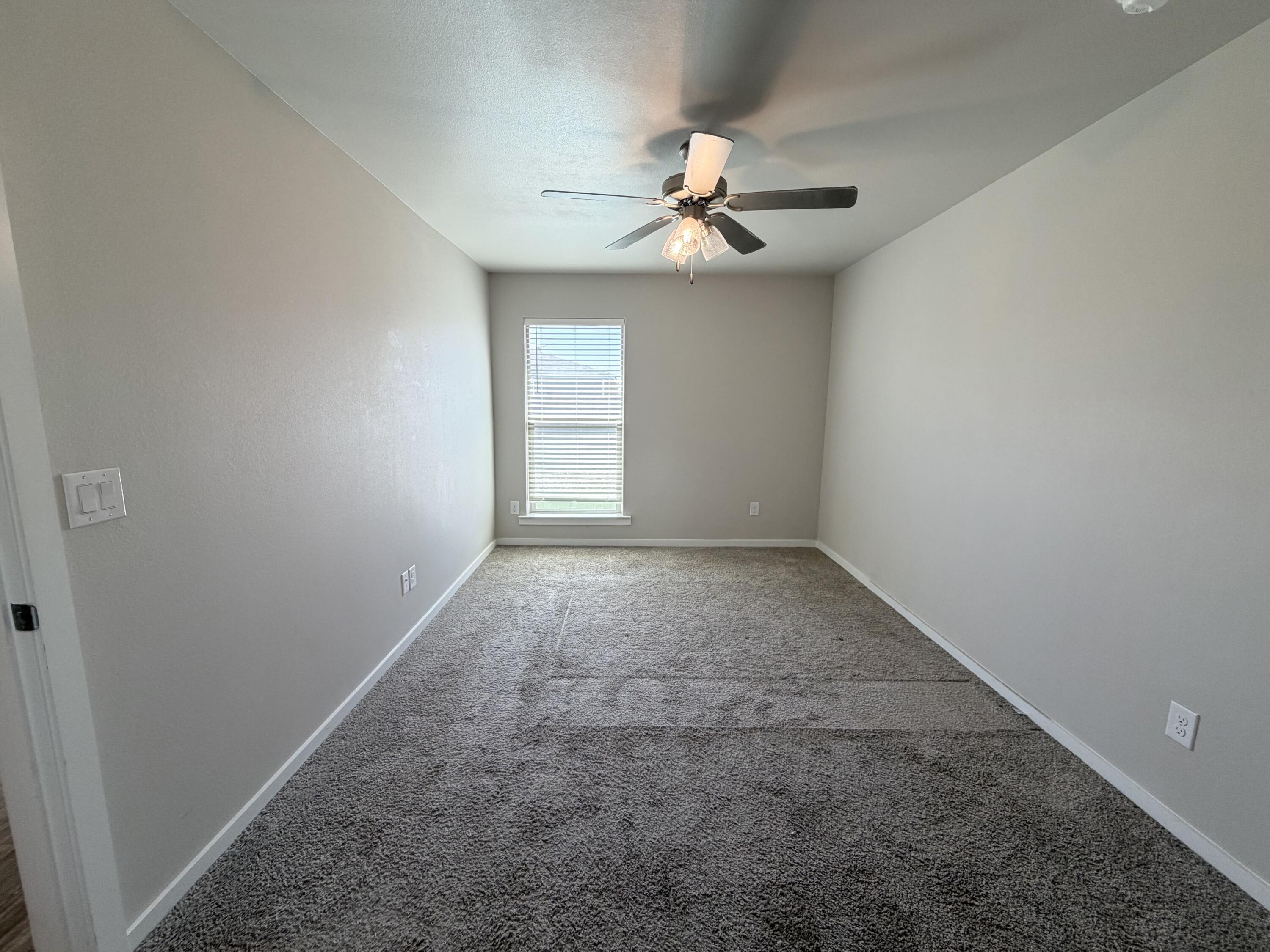 1619 133rd Street, Unit B Lubbock, TX 79423 - Photo 19 of 24 an empty room with windows and fan