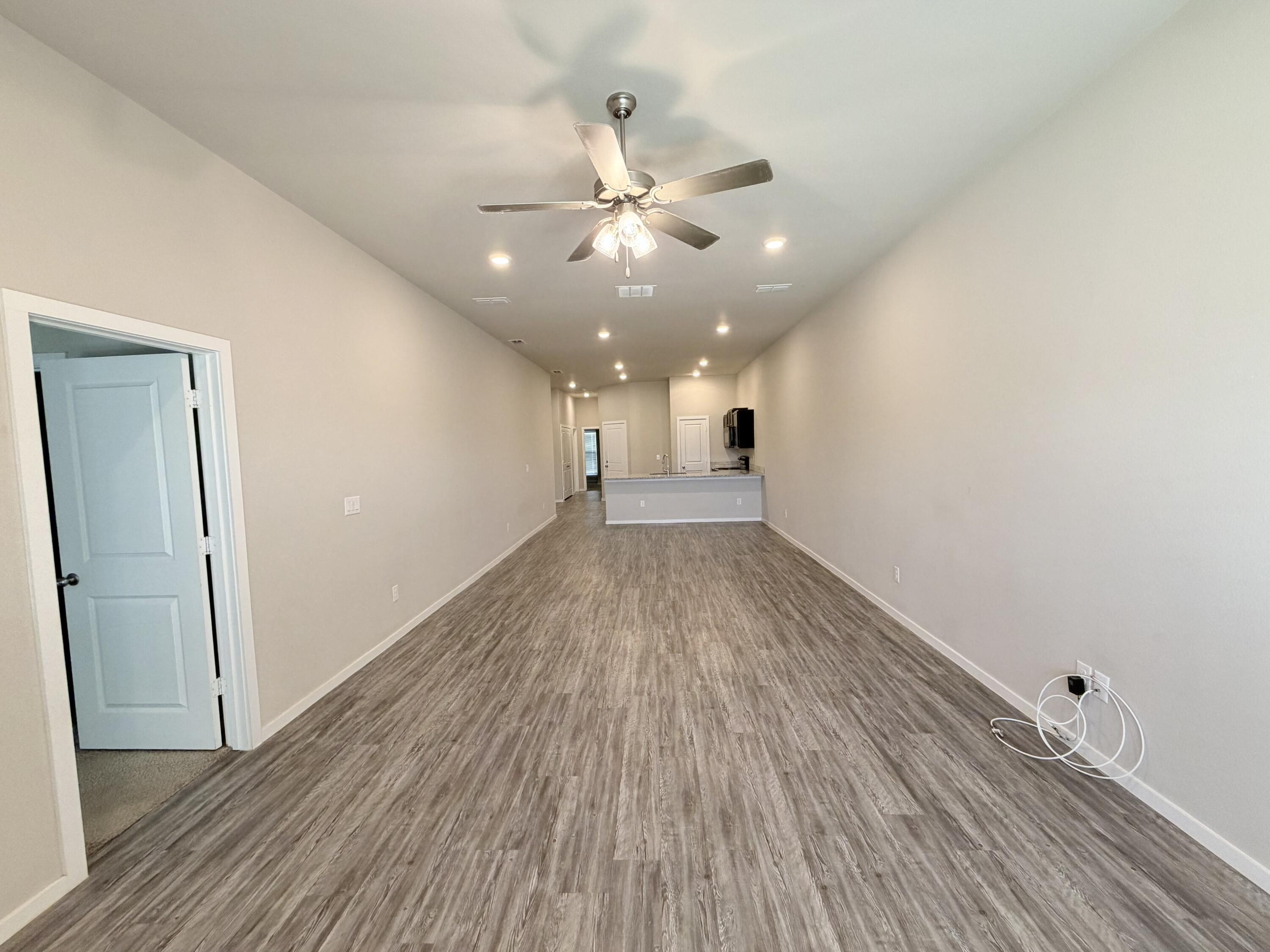 1619 133rd Street, Unit B Lubbock, TX 79423 - Photo 20 of 24 wooden floor in an empty room with a window