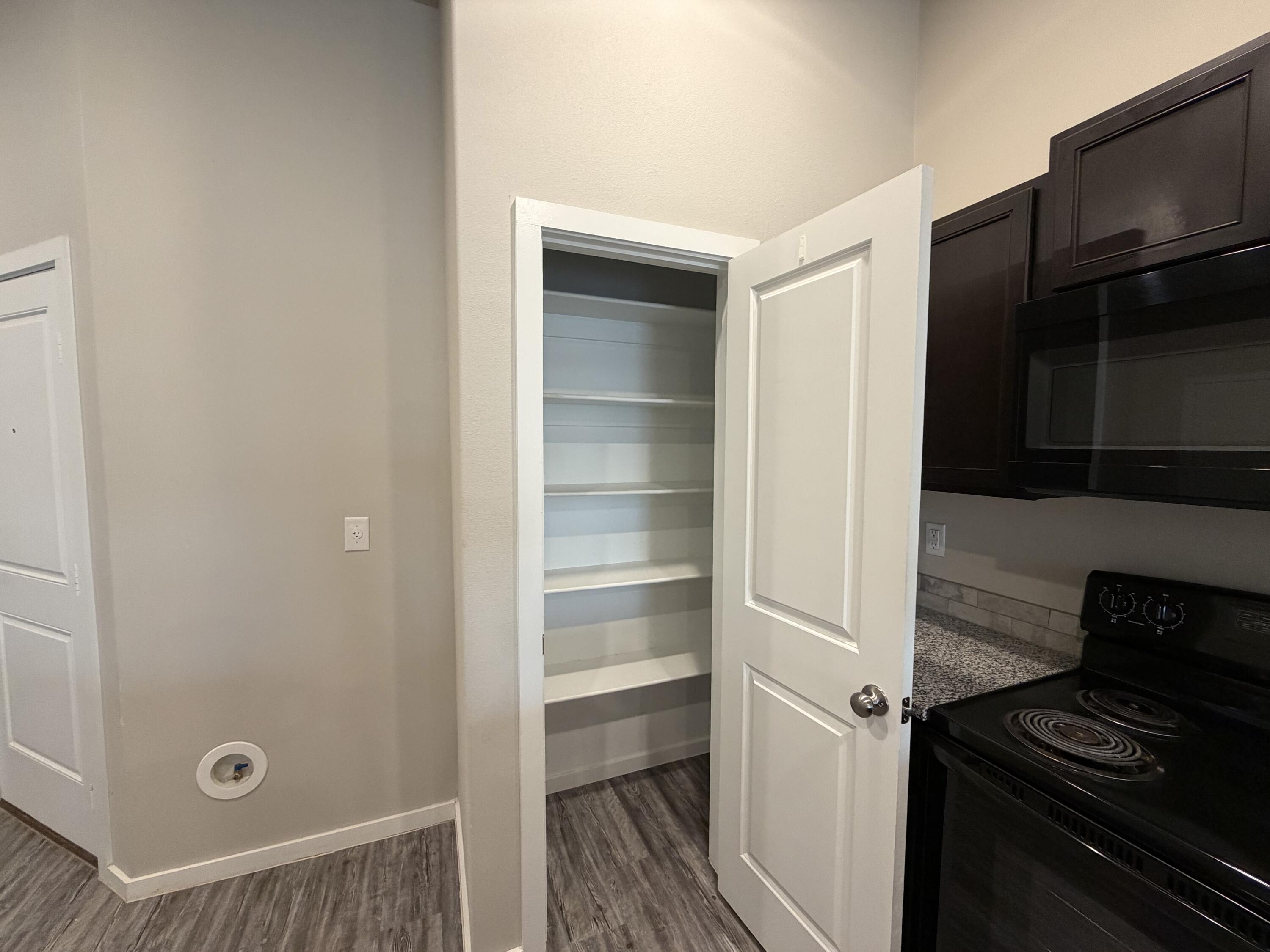 1619 133rd Street, Unit B Lubbock, TX 79423 - Photo 23 of 24 a kitchen with a refrigerator and a stove top oven