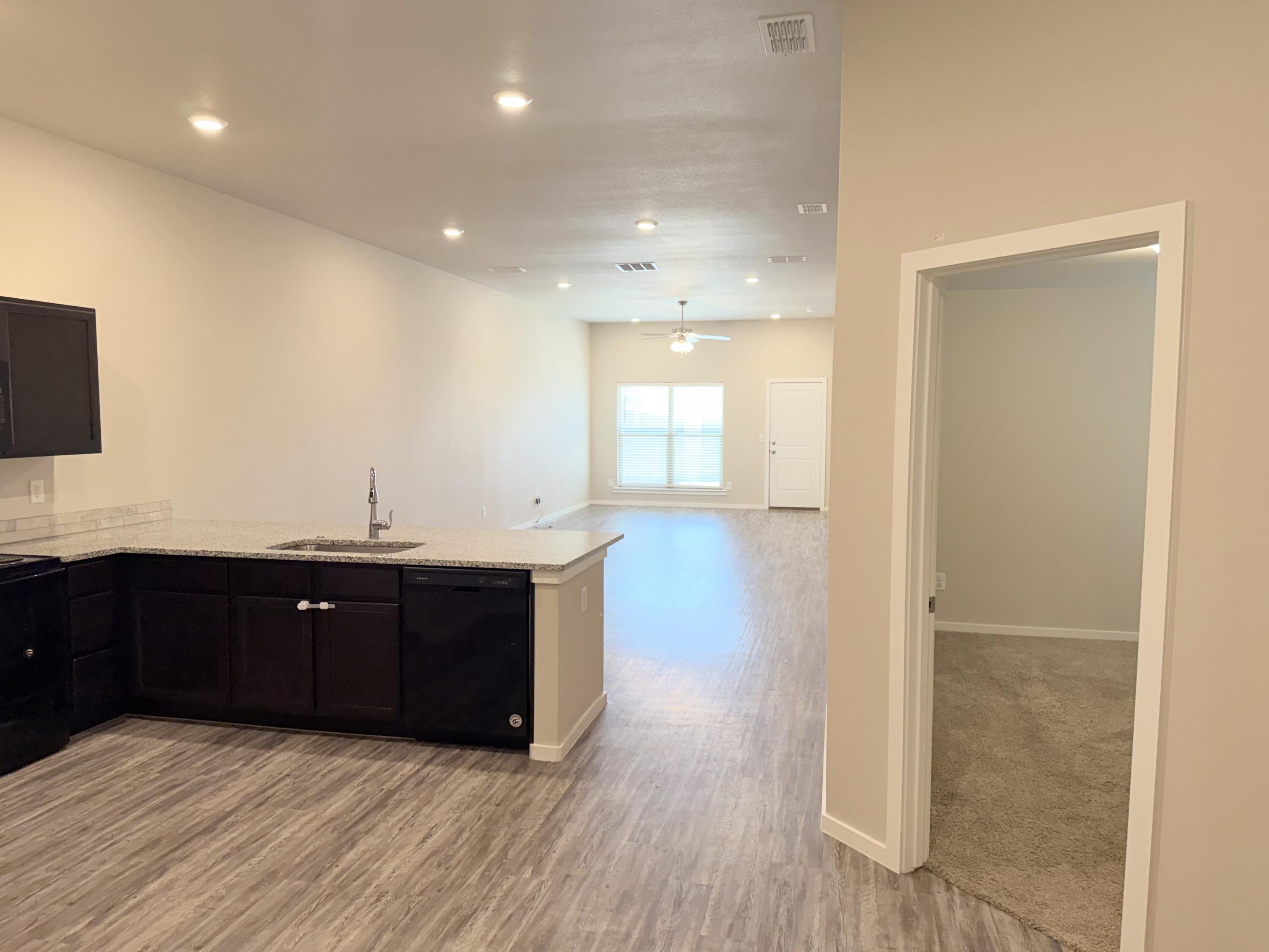 1619 133rd Street, Unit B Lubbock, TX 79423 - Photo 3 of 24 a spacious bathroom with a vanity and a mirror