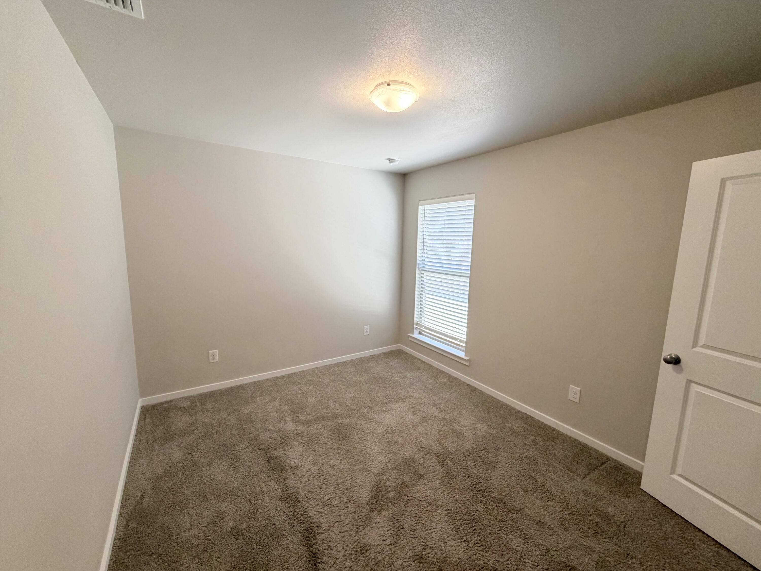 1619 133rd Street, Unit B Lubbock, TX 79423 - Photo 5 of 24 an empty room with a window