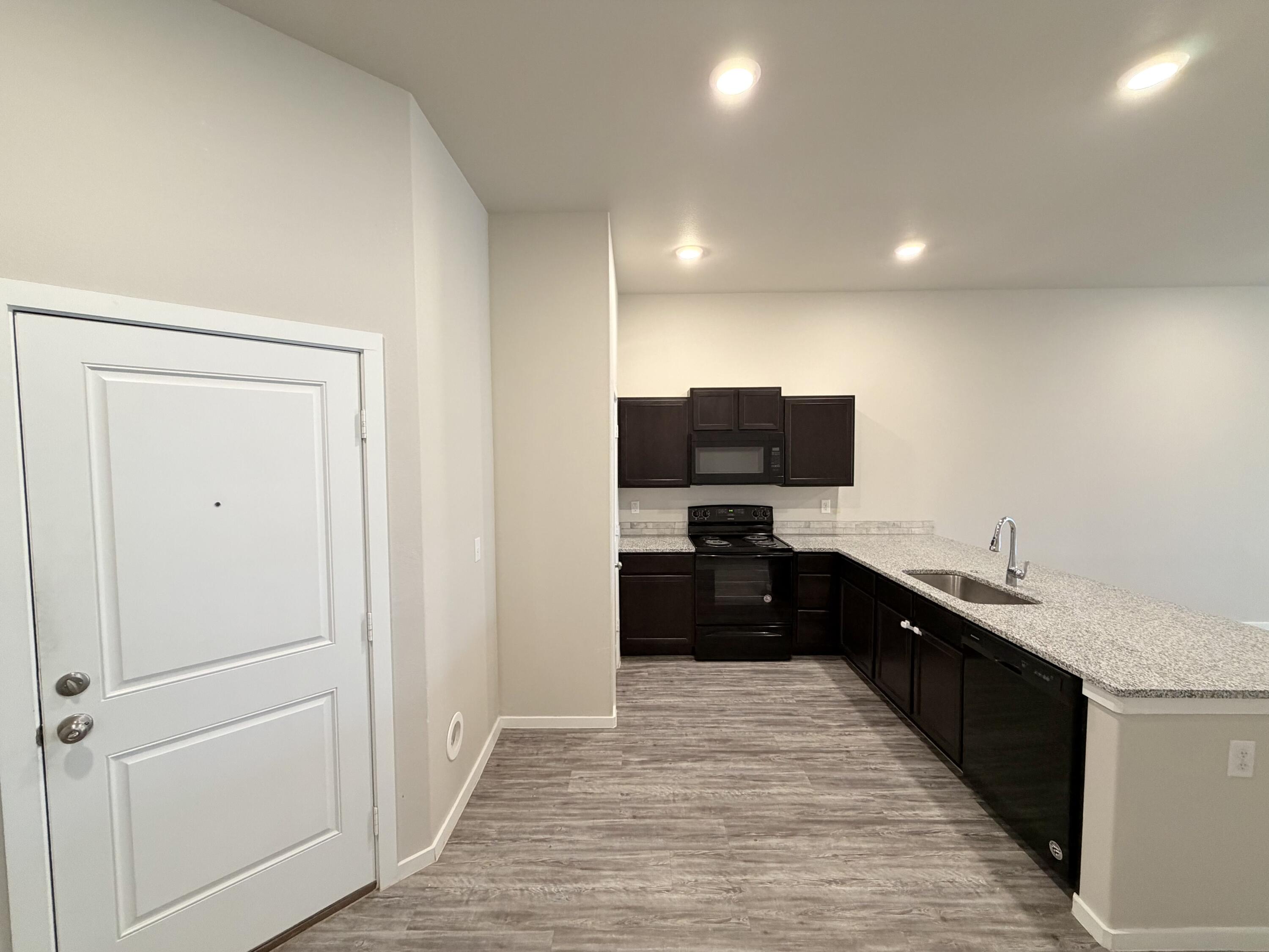 1619 133rd Street, Unit B Lubbock, TX 79423 - Photo 7 of 24 a living room with a sink and a dresser