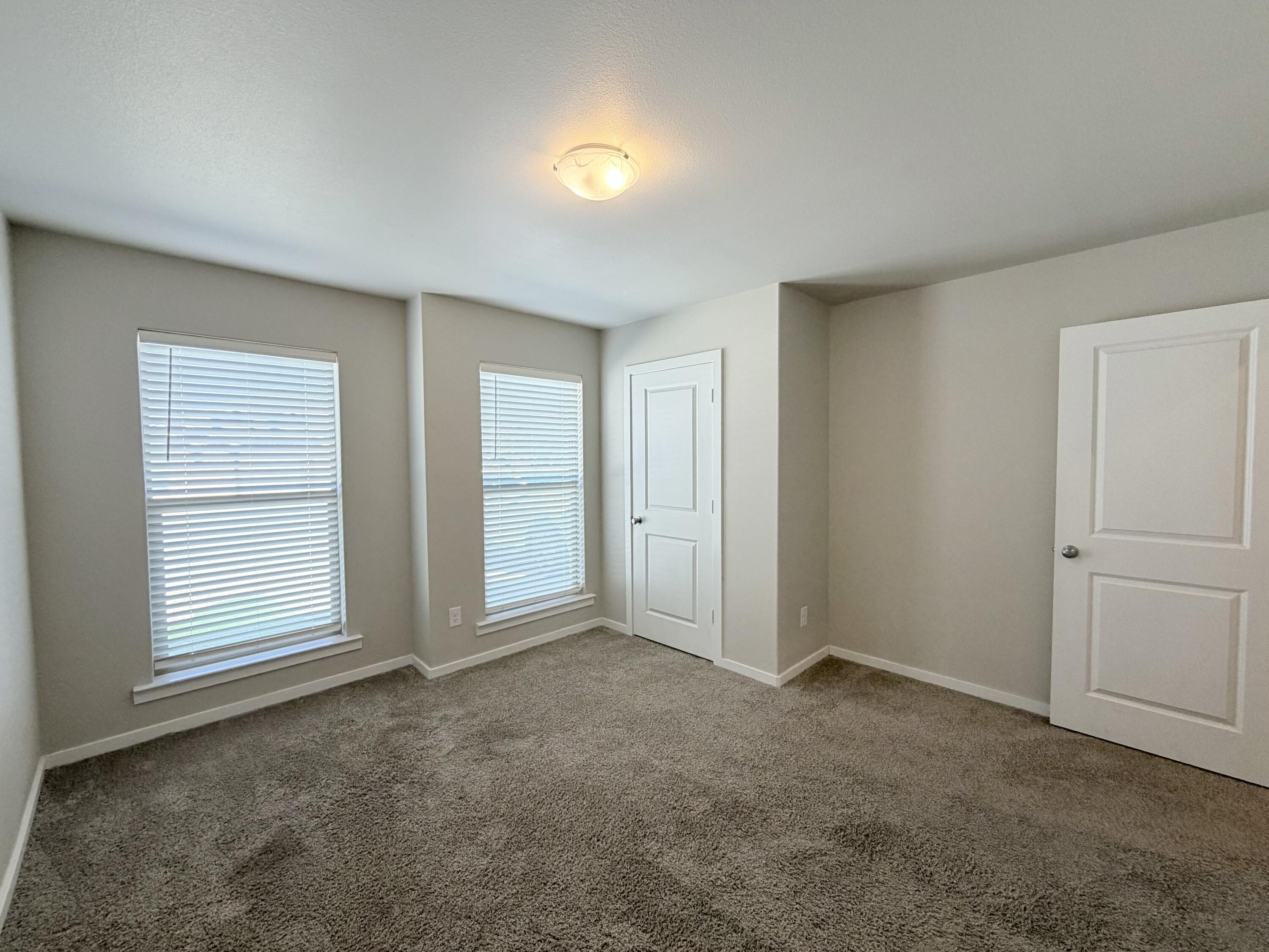 1619 133rd Street, Unit B Lubbock, TX 79423 - Photo 10 of 24 an empty room with windows