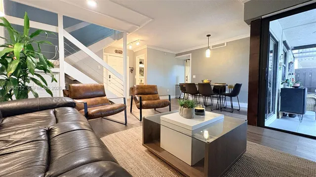 a living room with furniture and a potted plant