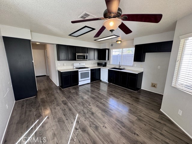 43370 Corte Benitez Temecula, CA 92592 - Photo 14 of 46 a large kitchen with a wooden floor and stainless steel appliances