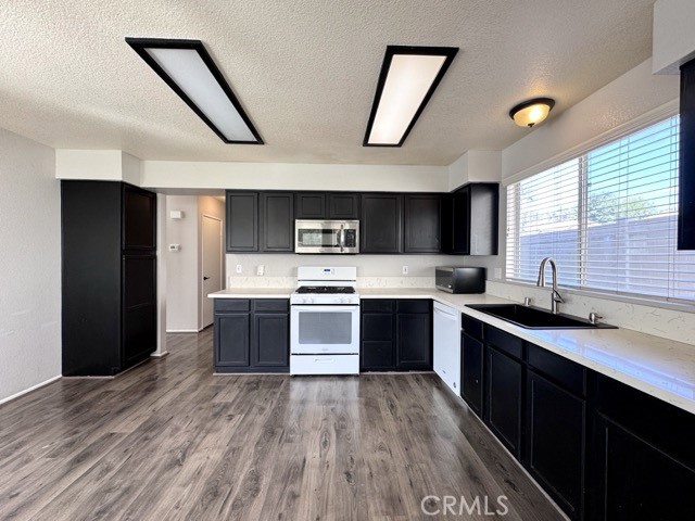43370 Corte Benitez Temecula, CA 92592 - Photo 15 of 46 a large kitchen with stainless steel appliances kitchen island granite countertop a sink and wooden cabinets