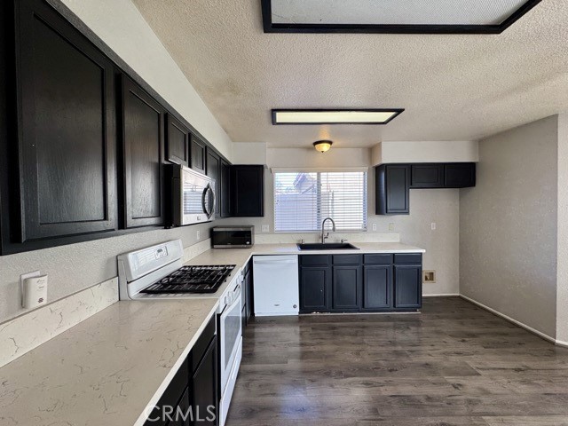 43370 Corte Benitez Temecula, CA 92592 - Photo 17 of 46 a kitchen with stainless steel appliances granite countertop a sink stove and refrigerator