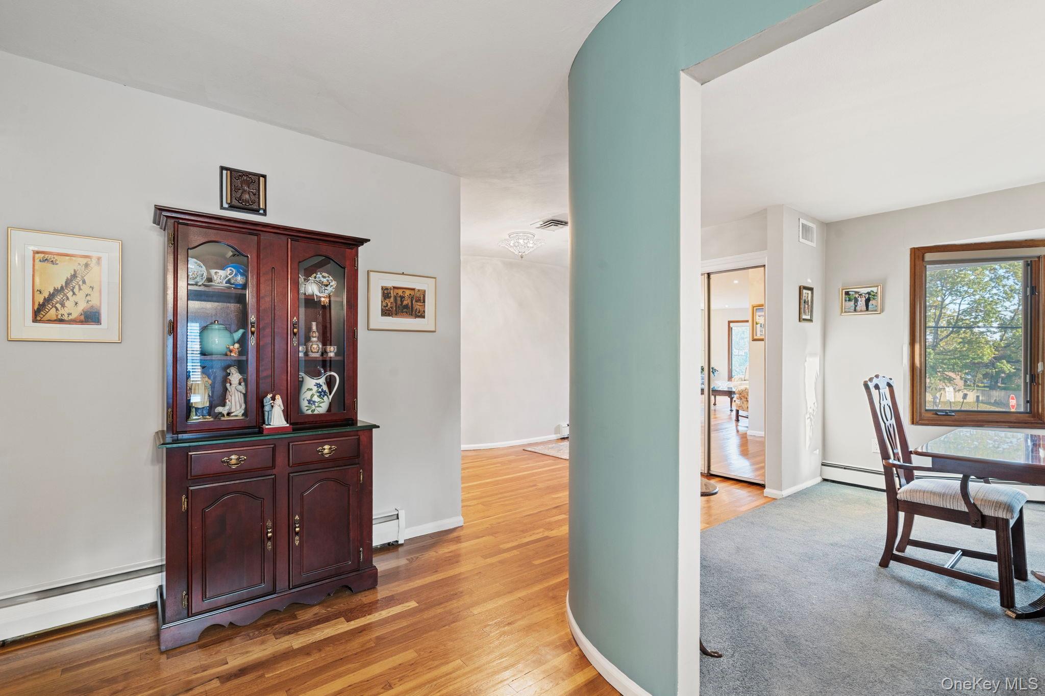 158 Old Courthouse Road Manhasset Hills, NY 11040 - Photo 18 of 47 a view of a hallway with wooden floor and windows
