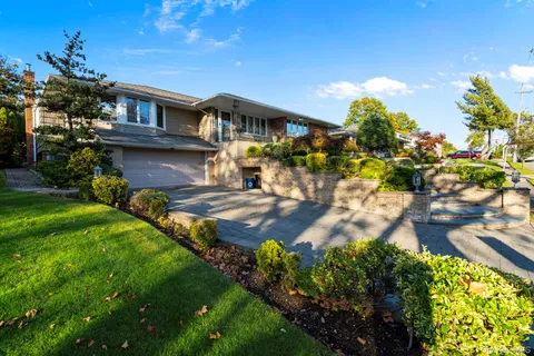 a front view of a house with garden