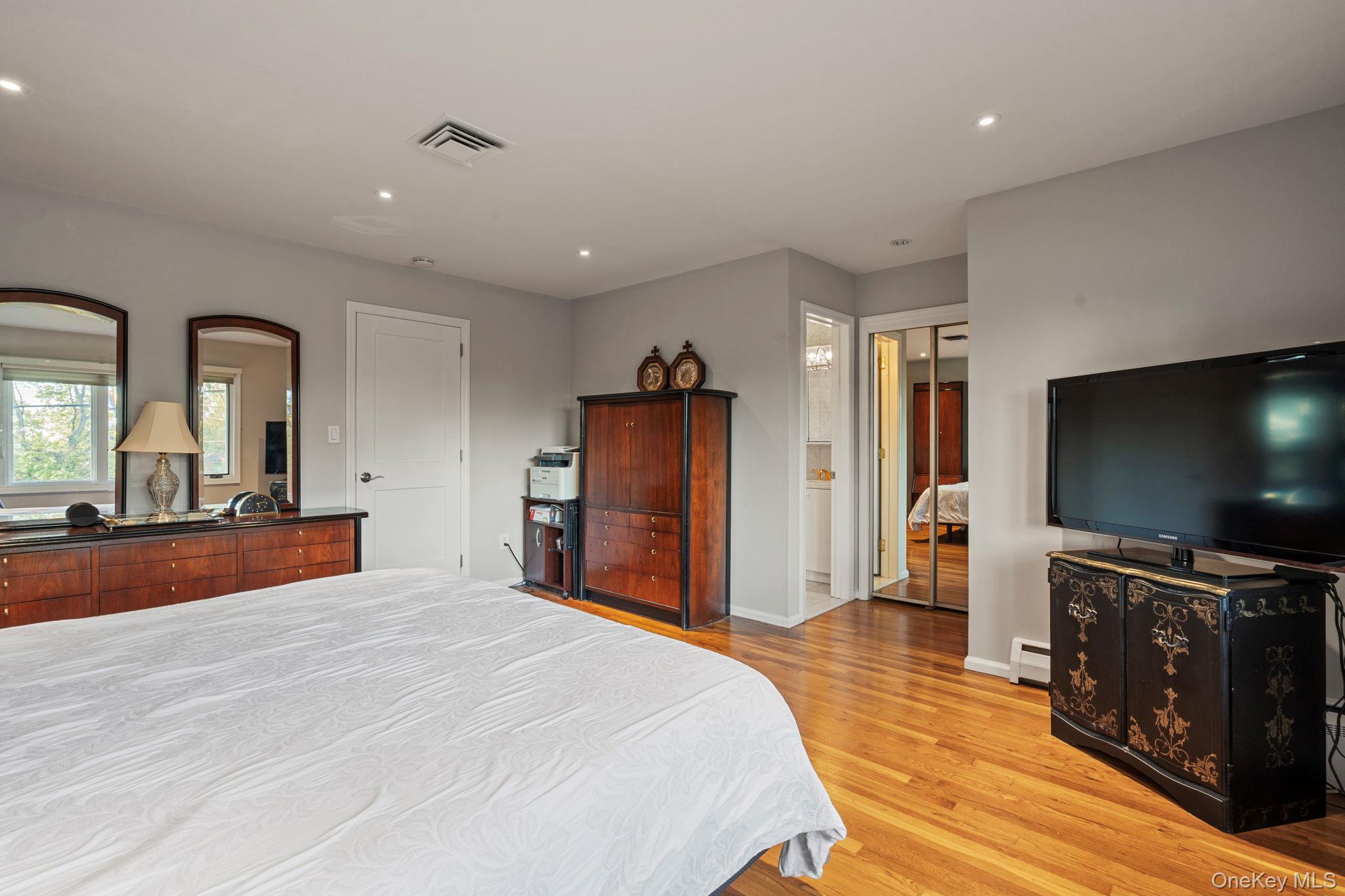 158 Old Courthouse Road Manhasset Hills, NY 11040 - Photo 21 of 47 a bedroom with furniture and a flat screen tv