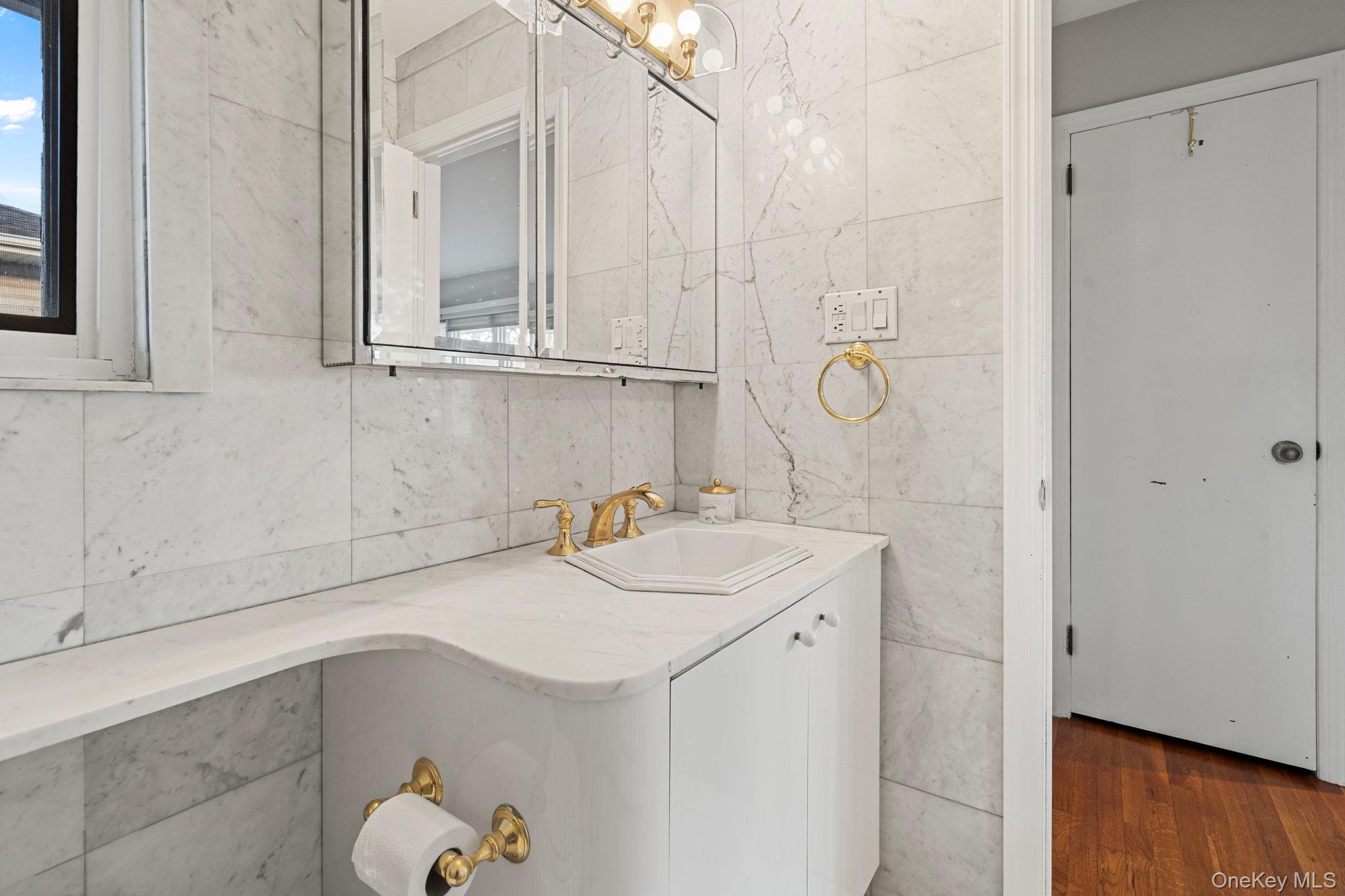 158 Old Courthouse Road Manhasset Hills, NY 11040 - Photo 23 of 47 a bathroom with a sink and a mirror