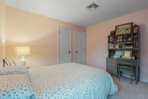 a bedroom with a bed and a book shelf