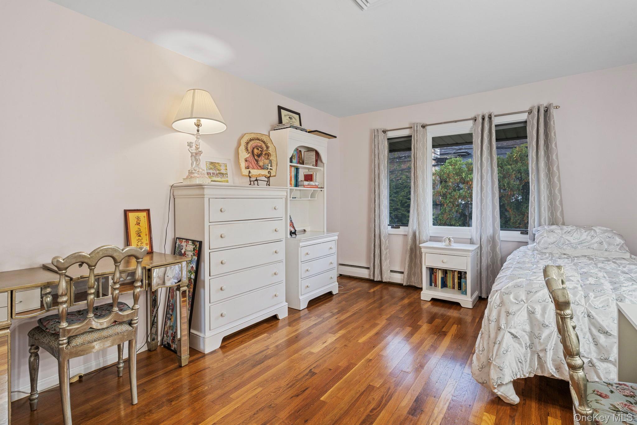 158 Old Courthouse Road Manhasset Hills, NY 11040 - Photo 28 of 47 a bedroom with a bed and wooden floor
