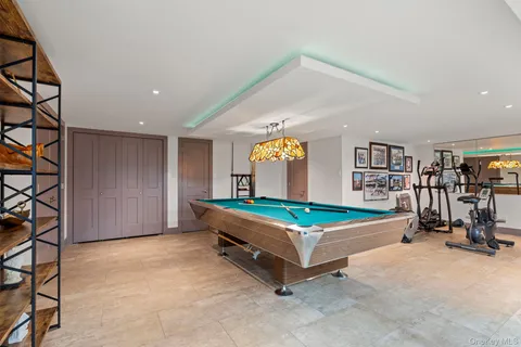 a room with gym equipment and pool table