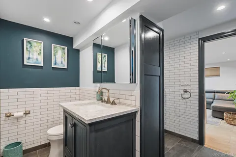 a bathroom with a toilet sink and mirror