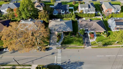 an aerial view of multiple houses with a yard