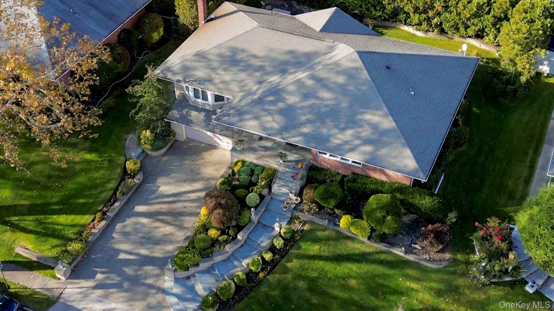 158 Old Courthouse Road Manhasset Hills, NY 11040 - Photo 42 of 47 a view of a yard with a house