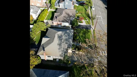 an aerial view of a residential house with outdoor space