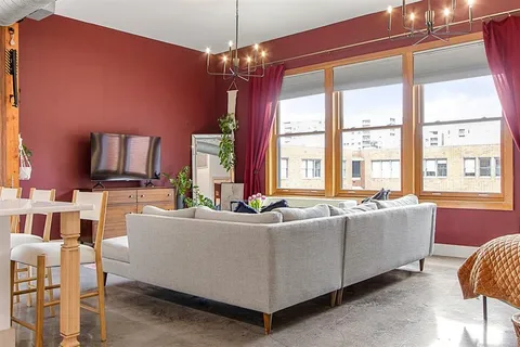 a living room with furniture and a chandelier