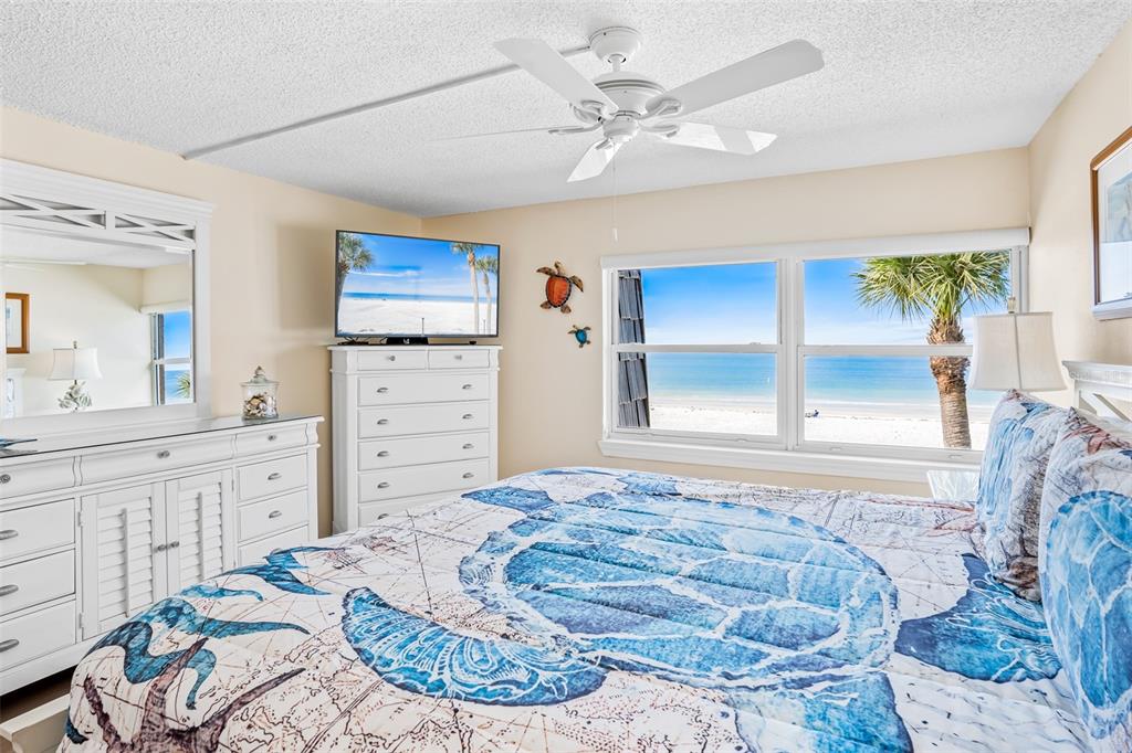 60 Gulf Boulevard, Unit 203 Indian Rocks Beach, FL 33785 - Photo 24 of 53 a bedroom with a bed and a dresser