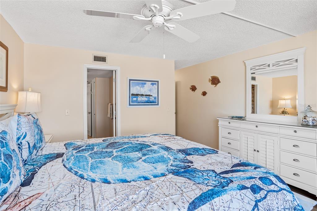 60 Gulf Boulevard, Unit 203 Indian Rocks Beach, FL 33785 - Photo 28 of 53 a bedroom with a large bed and a dresser