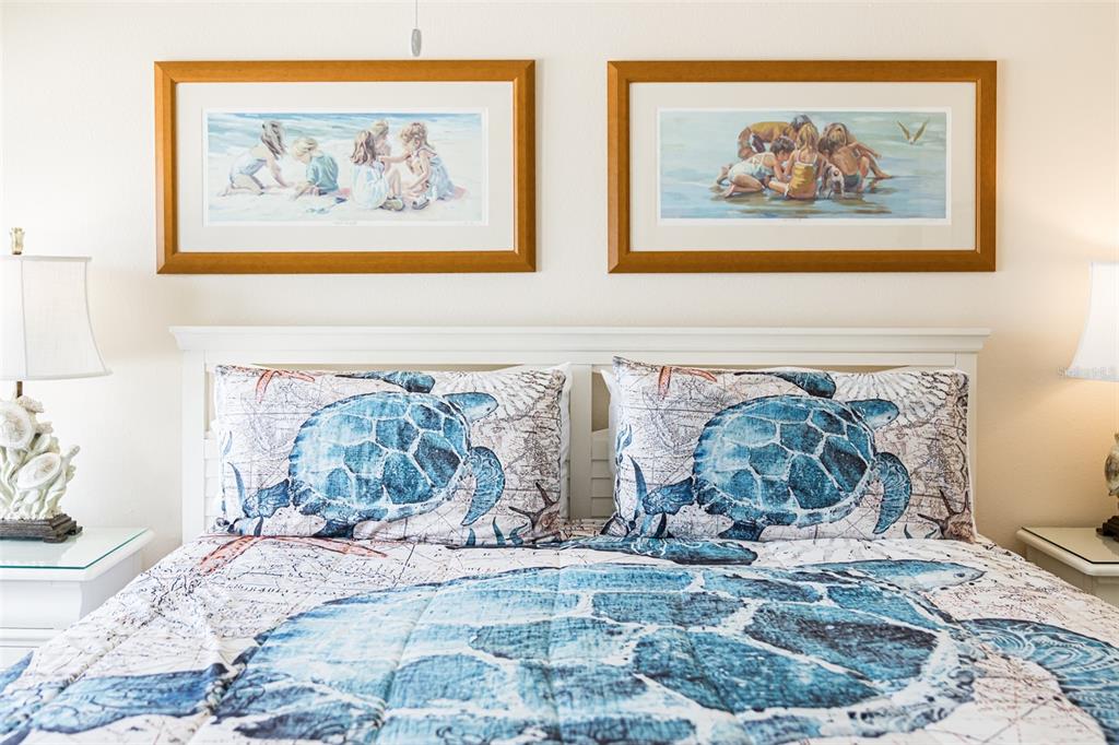 60 Gulf Boulevard, Unit 203 Indian Rocks Beach, FL 33785 - Photo 29 of 53 a bedroom with a bed and a painting on the wall
