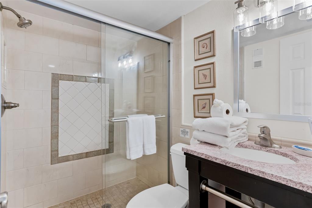 60 Gulf Boulevard, Unit 203 Indian Rocks Beach, FL 33785 - Photo 34 of 53 a bathroom with a granite countertop sink mirror and a toilet