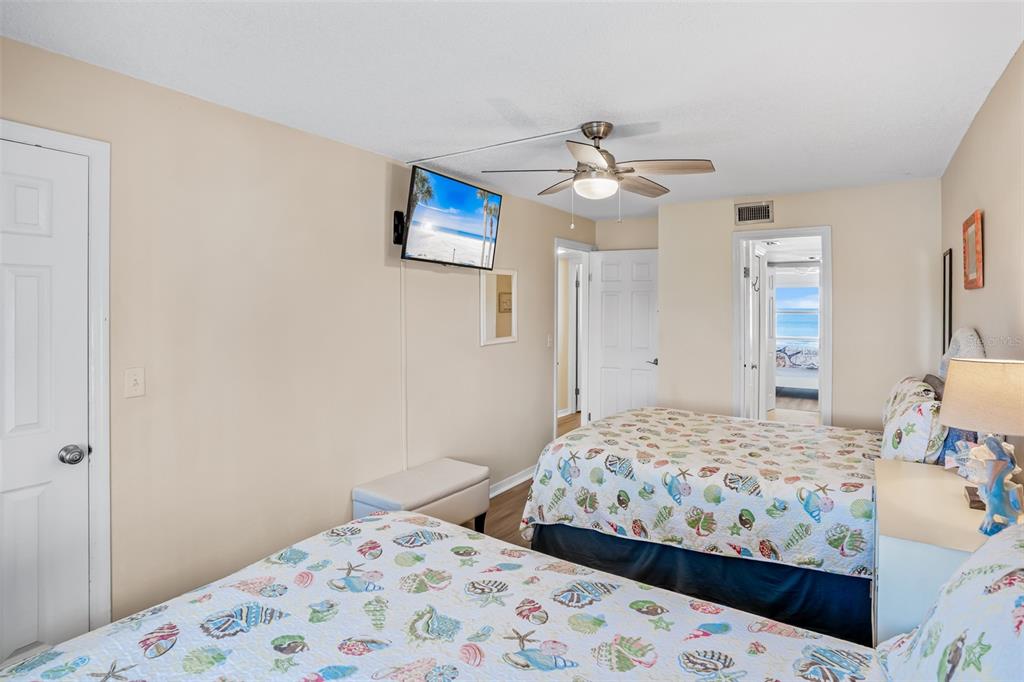 60 Gulf Boulevard, Unit 203 Indian Rocks Beach, FL 33785 - Photo 37 of 53 a bedroom with a bed and a dresser