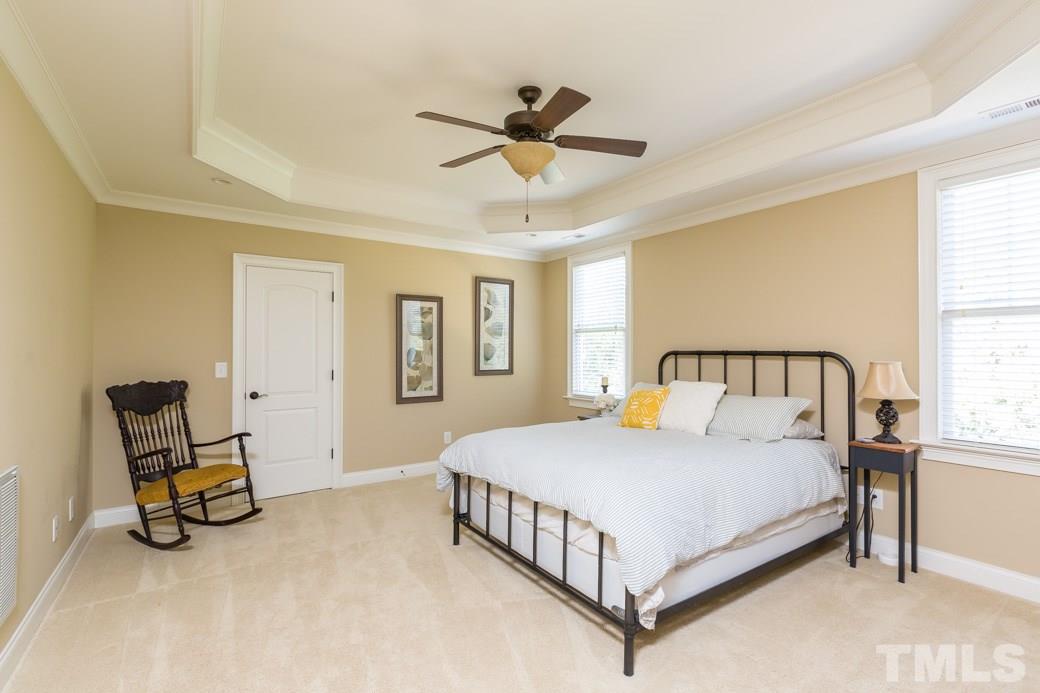 5342 Landguard Drive Raleigh, NC 27613 - Photo 14 of 25 a bedroom with a bed a couch and dresser