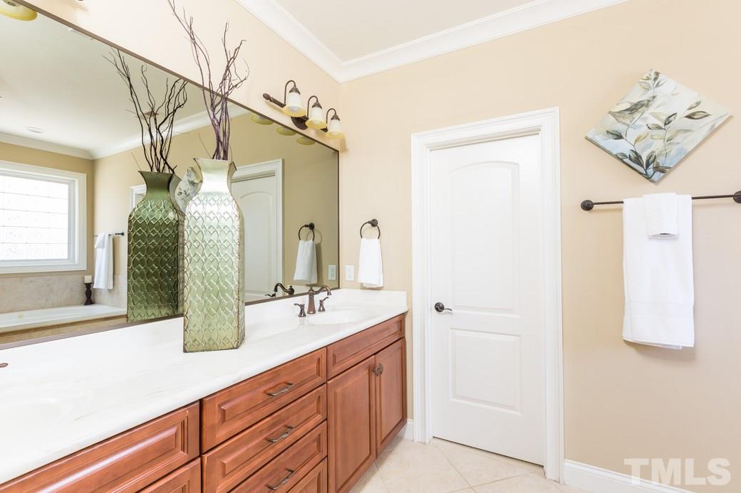 5342 Landguard Drive Raleigh, NC 27613 - Photo 15 of 25 a bathroom with a double vanity sink and a mirror