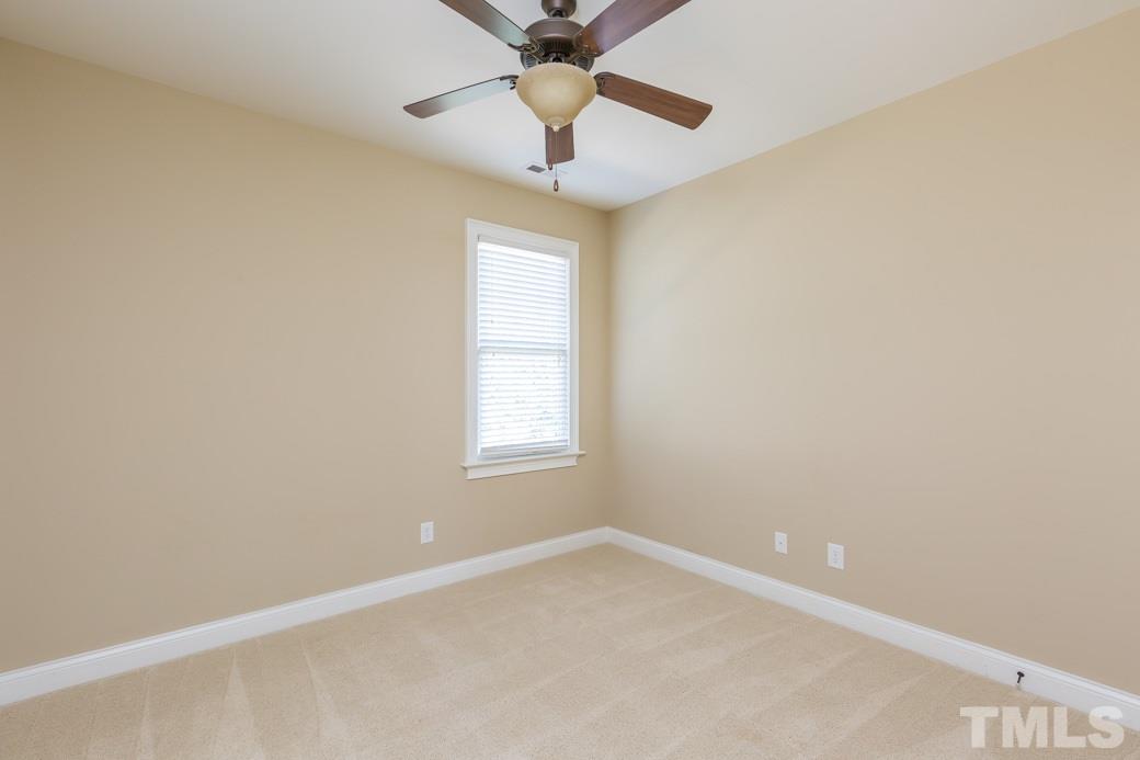 5342 Landguard Drive Raleigh, NC 27613 - Photo 19 of 25 an empty room with a window and a fan
