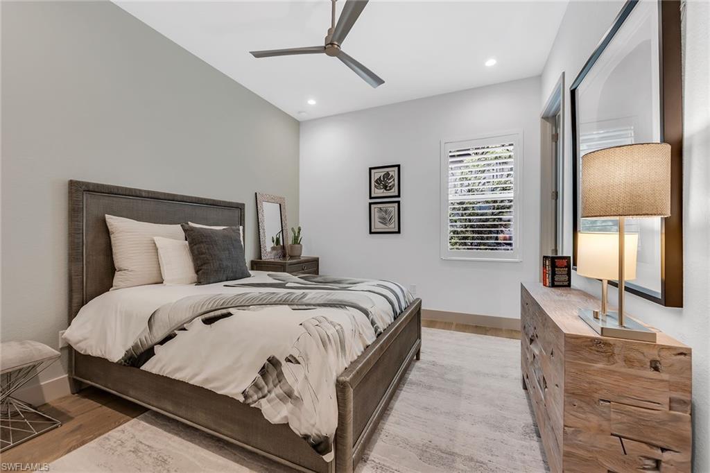 6184 Antigua Way Naples, FL 34113 - Photo 11 of 49 a bed room with a bed and a dresser