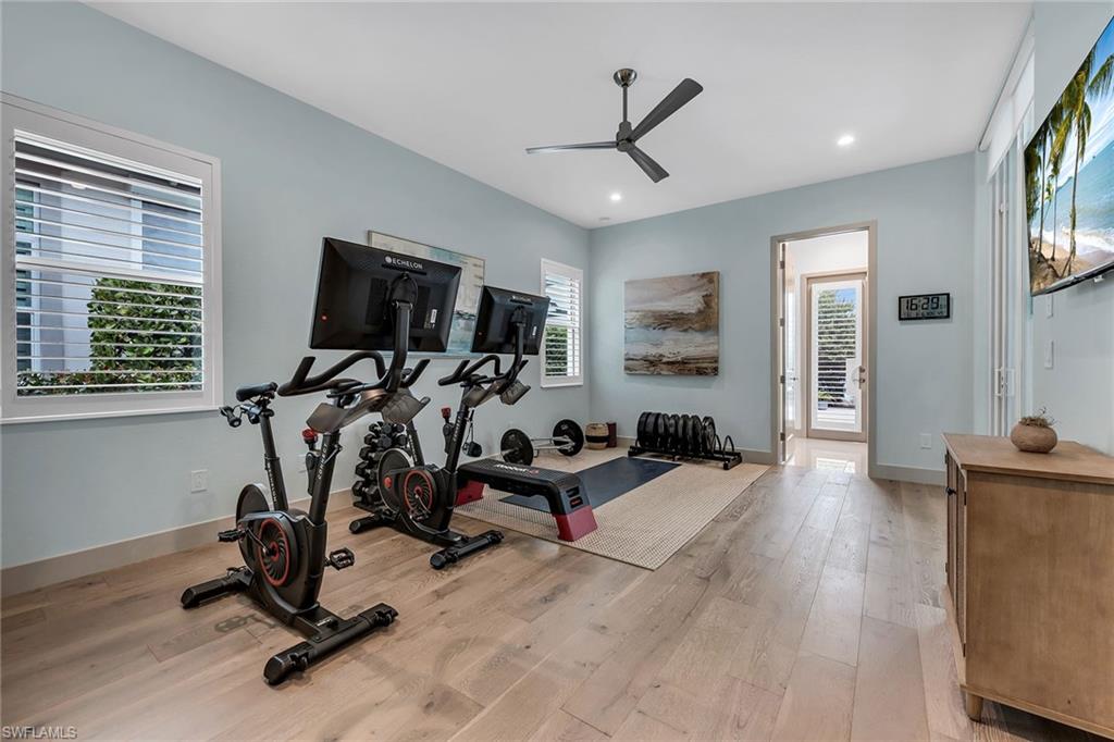 6184 Antigua Way Naples, FL 34113 - Photo 13 of 49 a view of a livingroom with furniture and a flat screen tv