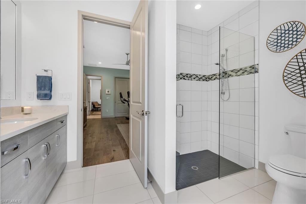 6184 Antigua Way Naples, FL 34113 - Photo 14 of 49 a bathroom with a sink a toilet and shower