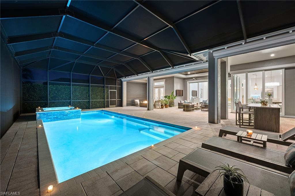 6184 Antigua Way Naples, FL 34113 - Photo 26 of 49 a view of a swimming pool with a patio