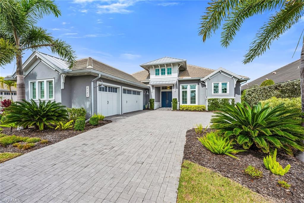 6184 Antigua Way Naples, FL 34113 - Photo 29 of 49 a front view of a house with a garden