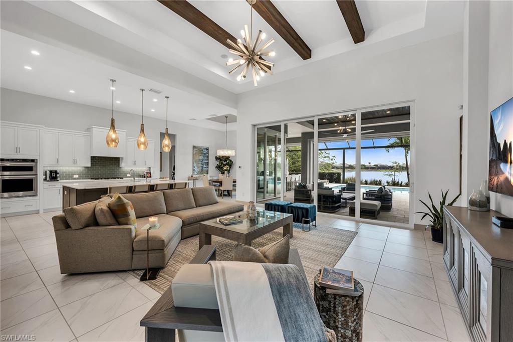 6184 Antigua Way Naples, FL 34113 - Photo 3 of 49 a living room with furniture and a large window