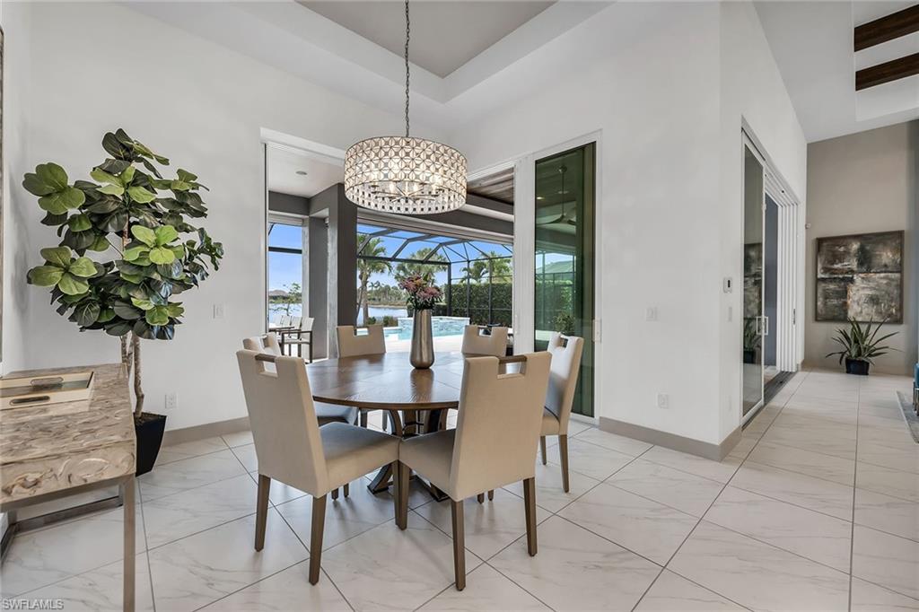 6184 Antigua Way Naples, FL 34113 - Photo 6 of 49 a view of a dining room with furniture wooden floor and chandelier