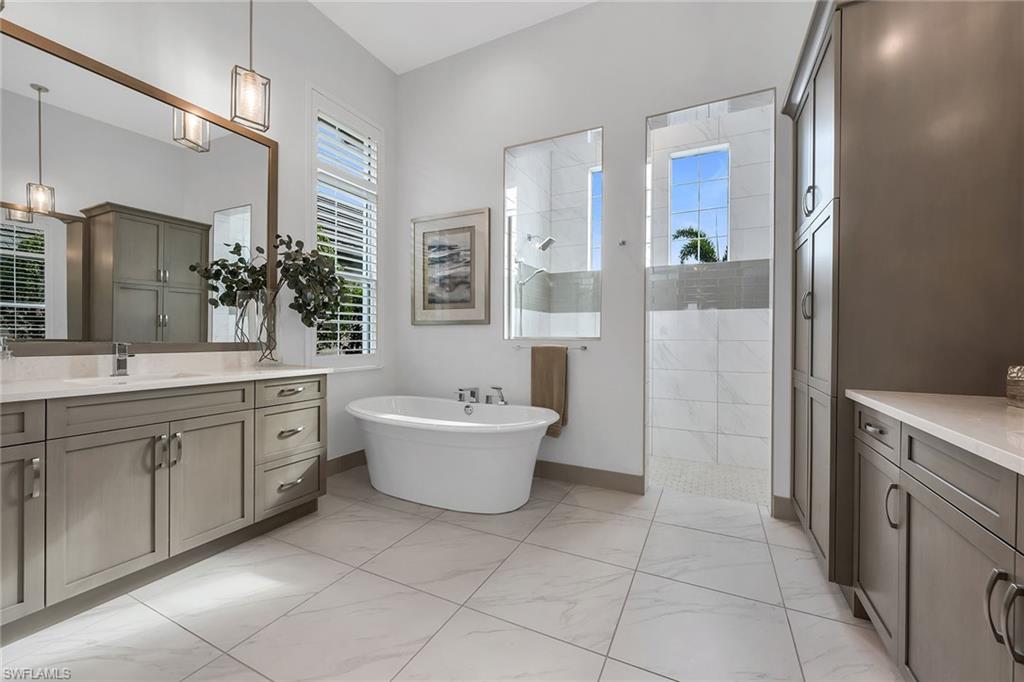 6184 Antigua Way Naples, FL 34113 - Photo 8 of 49 a spacious bathroom with a bathtub sink and toilet