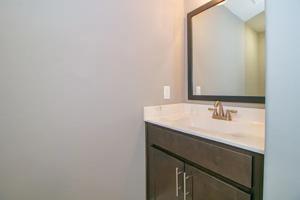 an empty room with a window and a ceiling fan