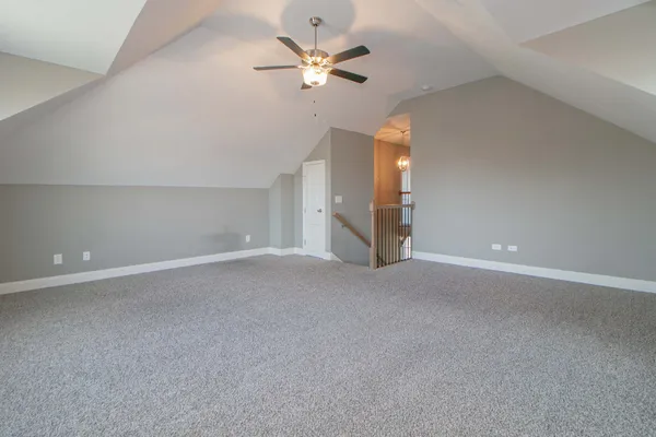 a view of an empty room and a ceiling fan