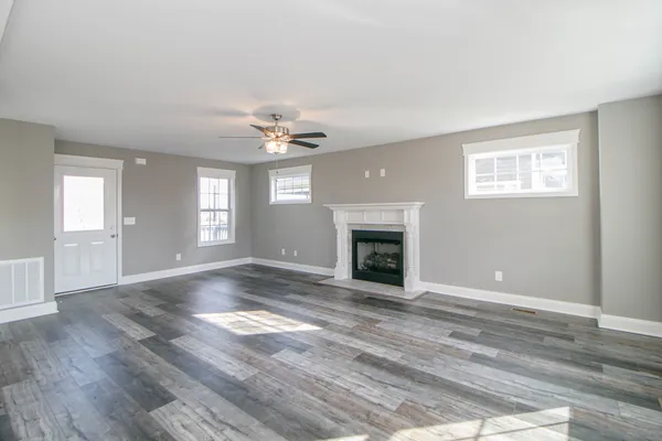 a kitchen with stainless steel appliances granite countertop a stove top oven a sink and a refrigerator