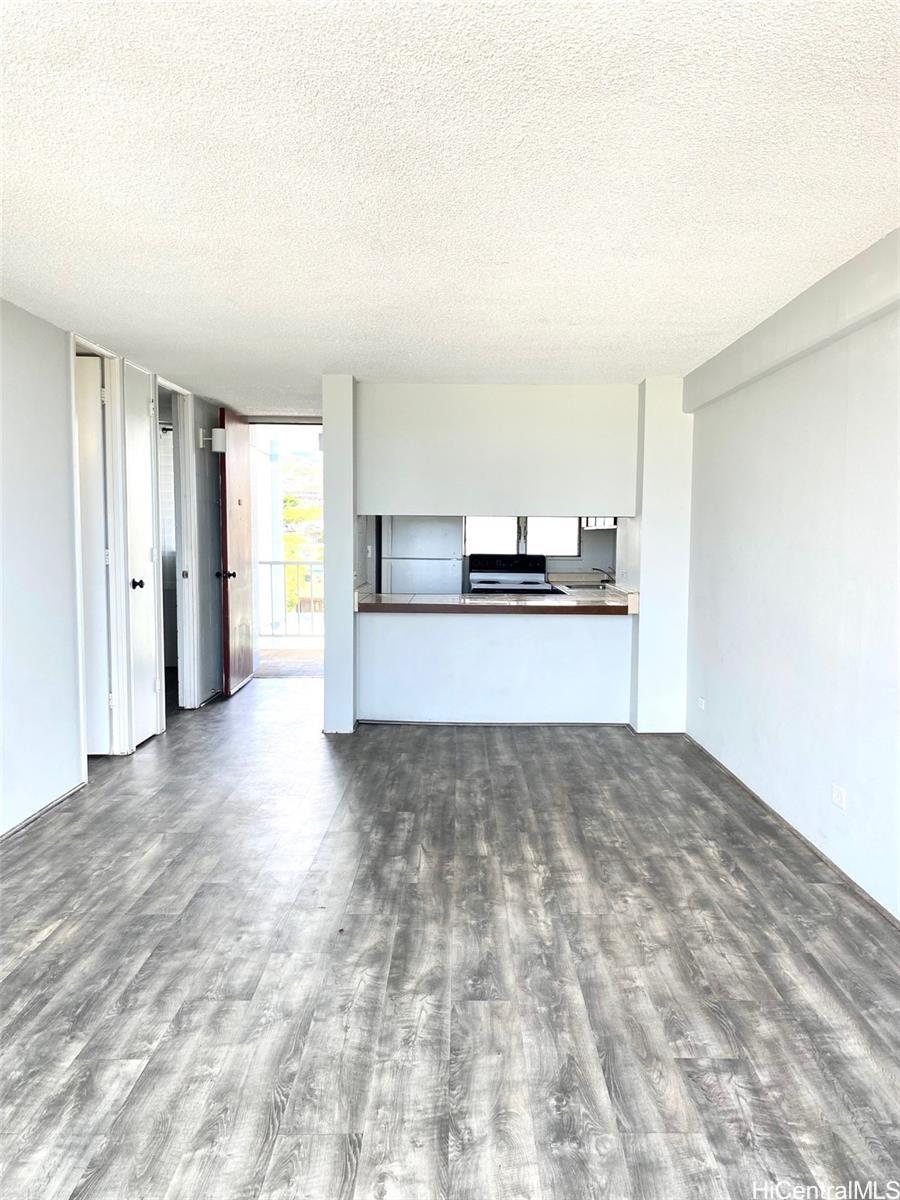 99-70 Kauhale Street, Unit 606 Aiea, HI 96701 - Photo 2 of 8 a view of a kitchen with a sink and a refrigerator