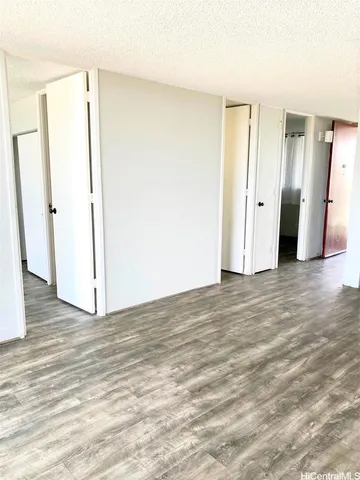 a view of a room with wooden floor