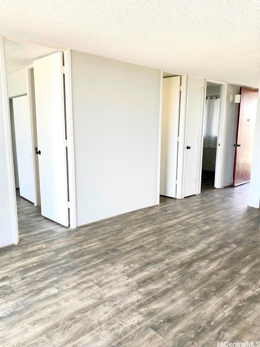 99-70 Kauhale Street, Unit 606 Aiea, HI 96701 - Photo 4 of 8 a view of a room with wooden floor