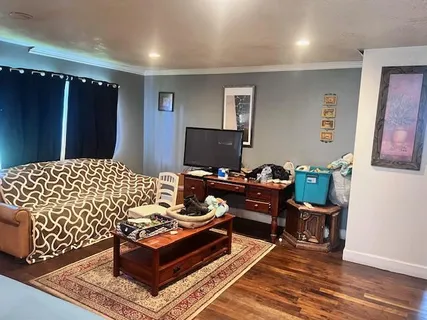 a bedroom with furniture and a window
