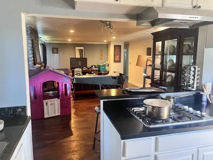 a kitchen with stainless steel appliances granite countertop a stove and a wooden cabinets